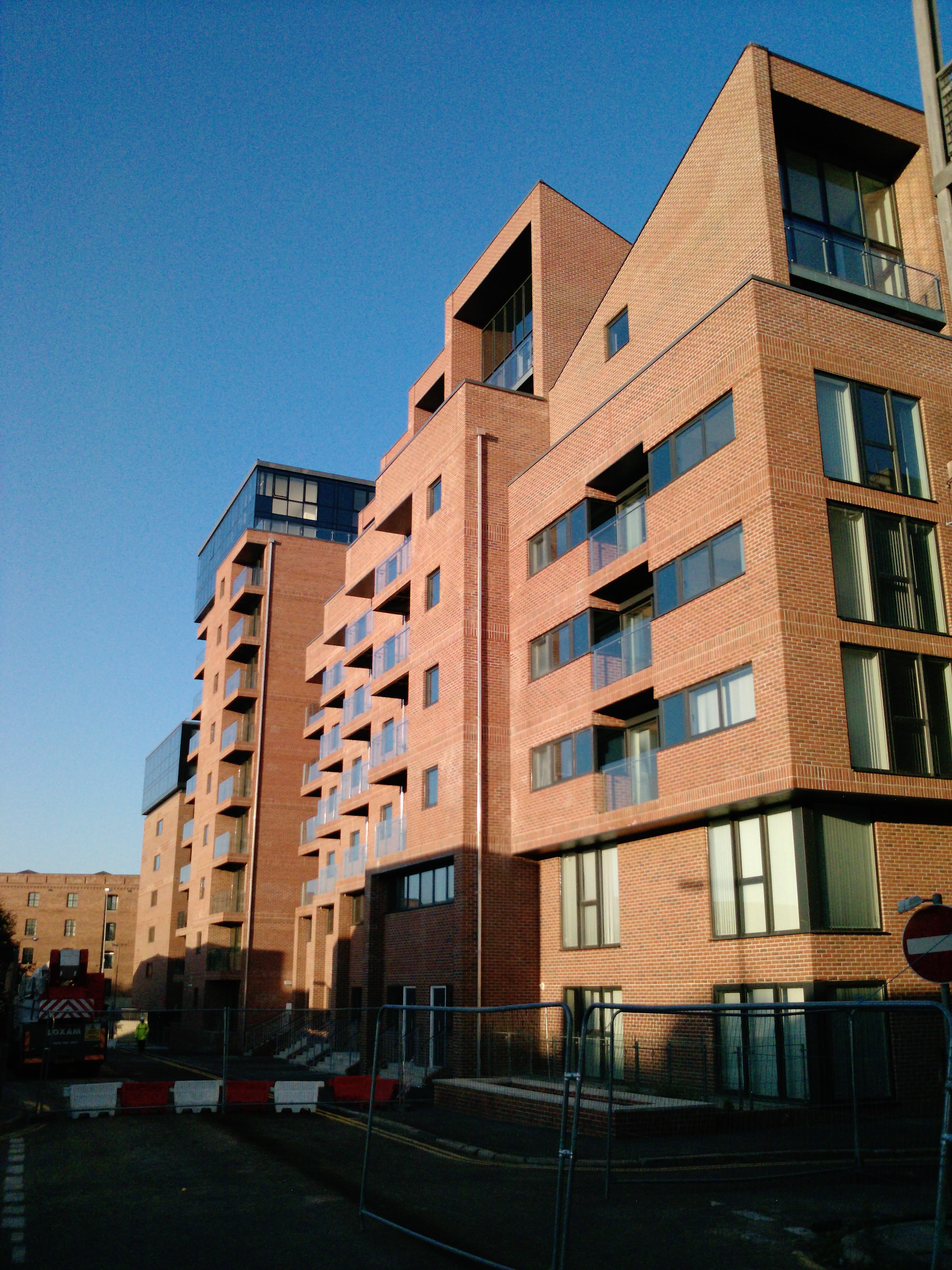 Site photograph — apartments and glazed penthouse façades