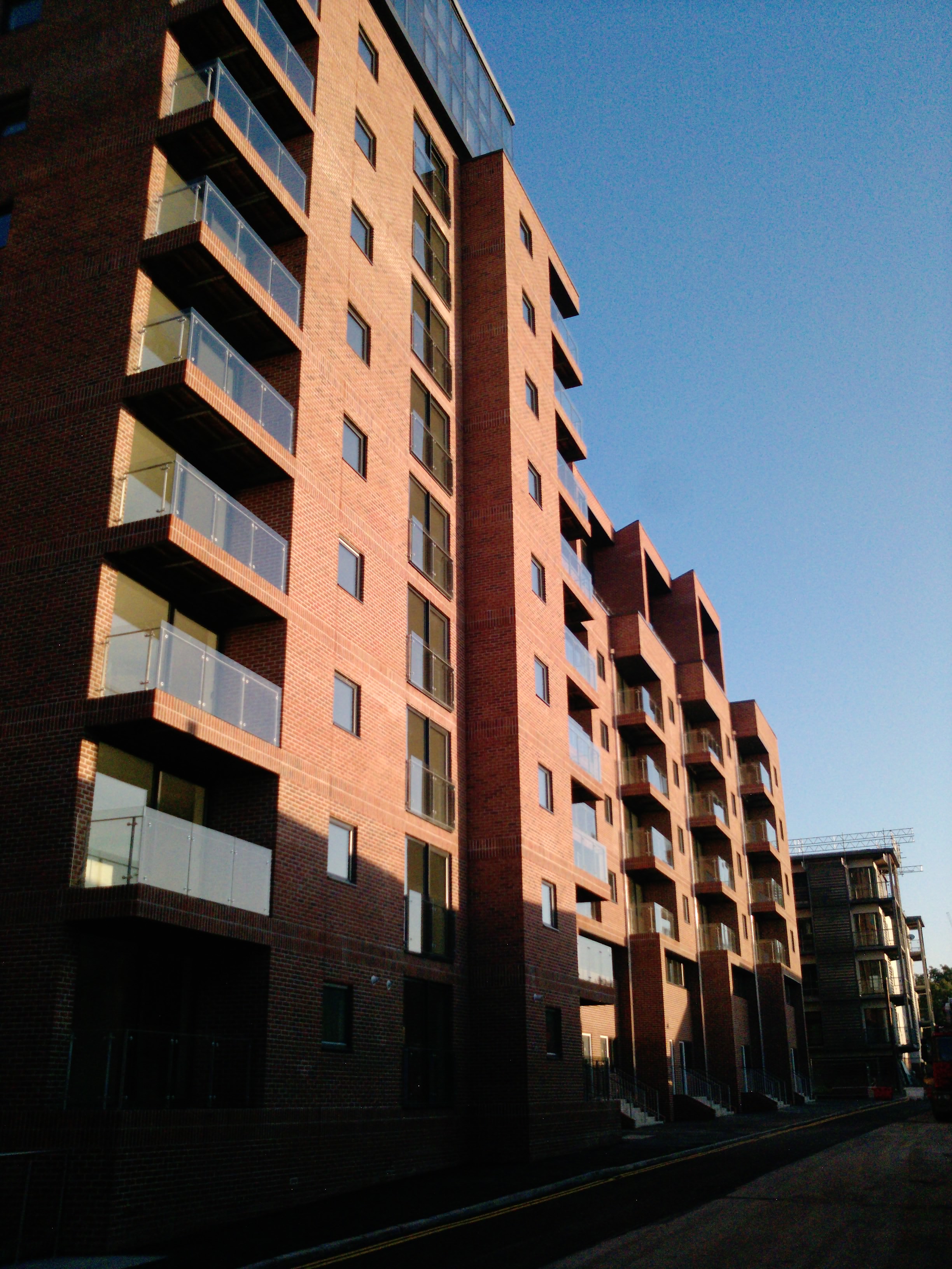 Site photograph — brick elevations and glazed balconies