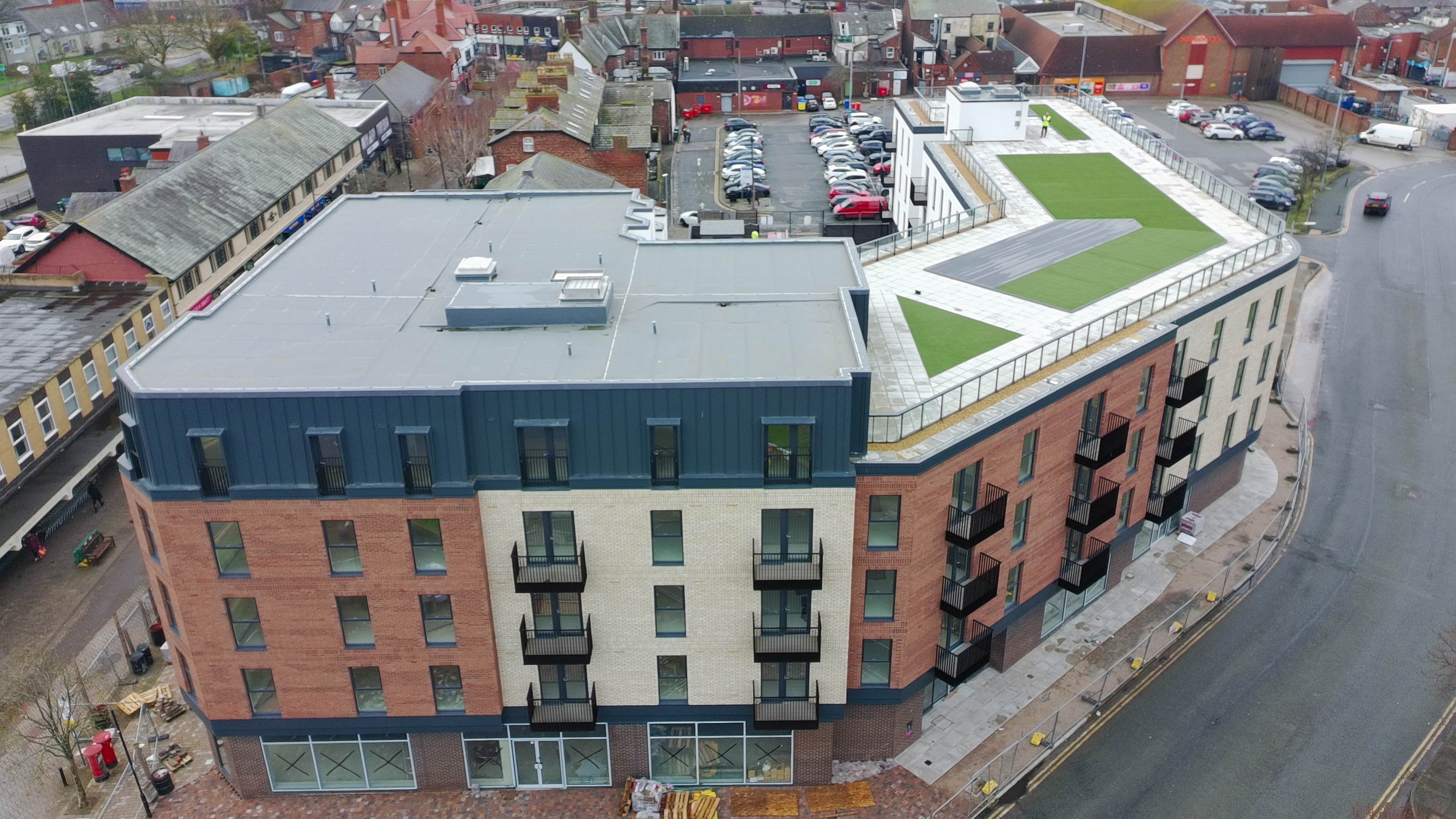 Upper-floor apartments and mixed brick façades at Moorside Place